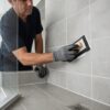 Professional bathroom regrouting in Bentleigh with fresh grout applied between shower wall tiles.