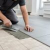 Installing new tiles over existing tiles in a home renovation