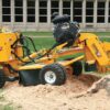 Stump grinding cost in Melbourne showing a professional removing a tree stump with a stump grinder